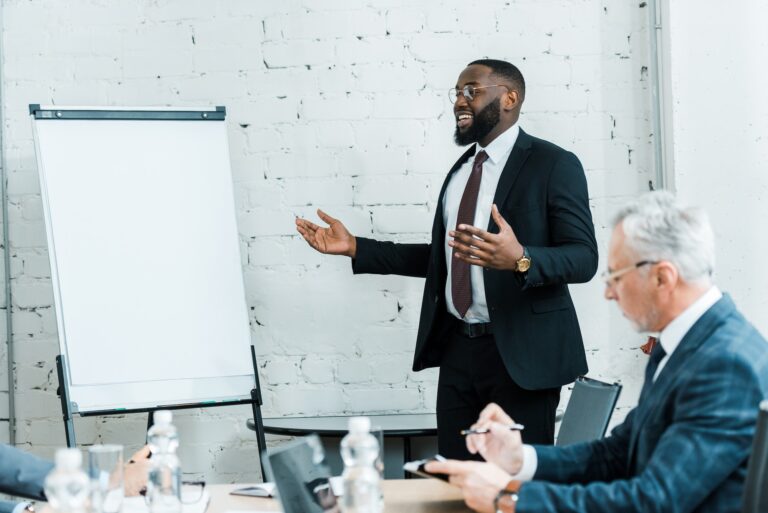 happy african american business coach talking near white board and colleague